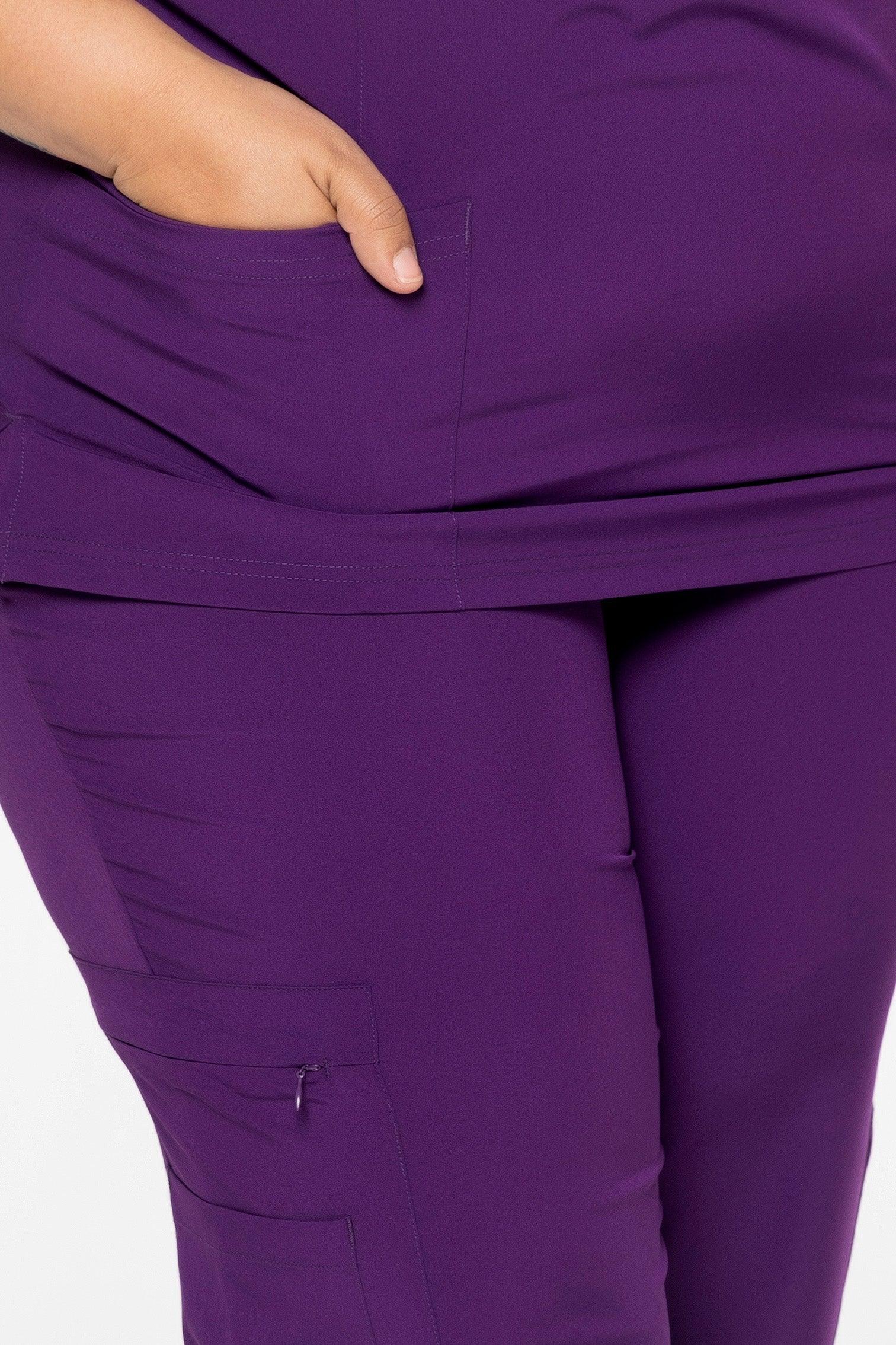 Close-up of hand in pocket on purple medical scrub pants with side zipper pocket